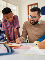 Teacher writing with an elementary school student