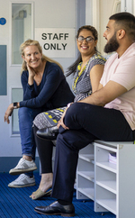 Teachers talk to each other in a staff only area in school