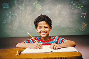 young boy writing